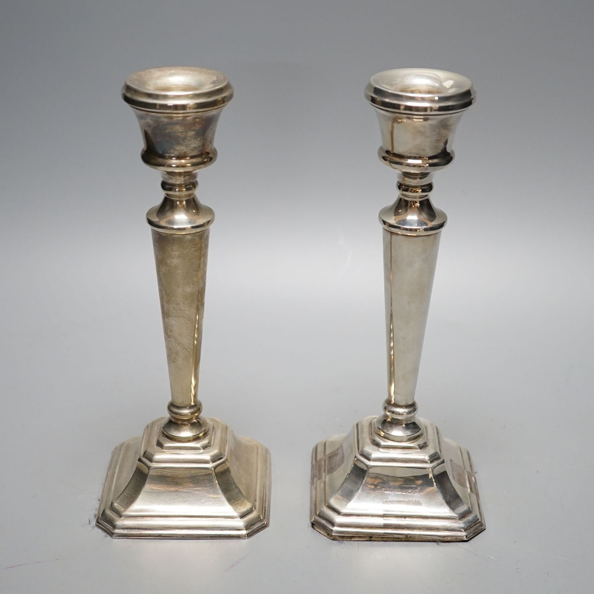 A modern pair of silver mounted candlesticks, JD Ltd, Birmingham, 2000, height 21.5cm, weighted.